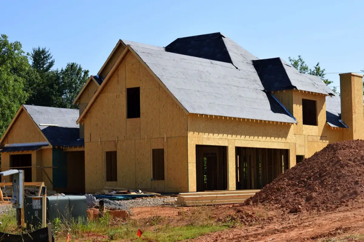 House with new roof decking and synthetic underlayment during a roof replacement in Garland, TX